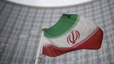 A national flag of Iran waves in front of the building of the International Atomic Energy Agency, IAEA, in Vienna, Austria.