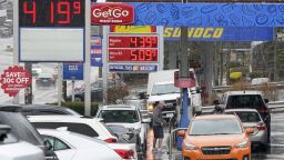 People pump gas at a Giant Eagle GetGo where a gallon of unleaded regular gas is $4.19.9, while at a neighboring Sunoco station, rear, a gallon of unleaded regular is $4.39.9, in Mount Lebanon, Pa., Monday, March 7, 2022. 
