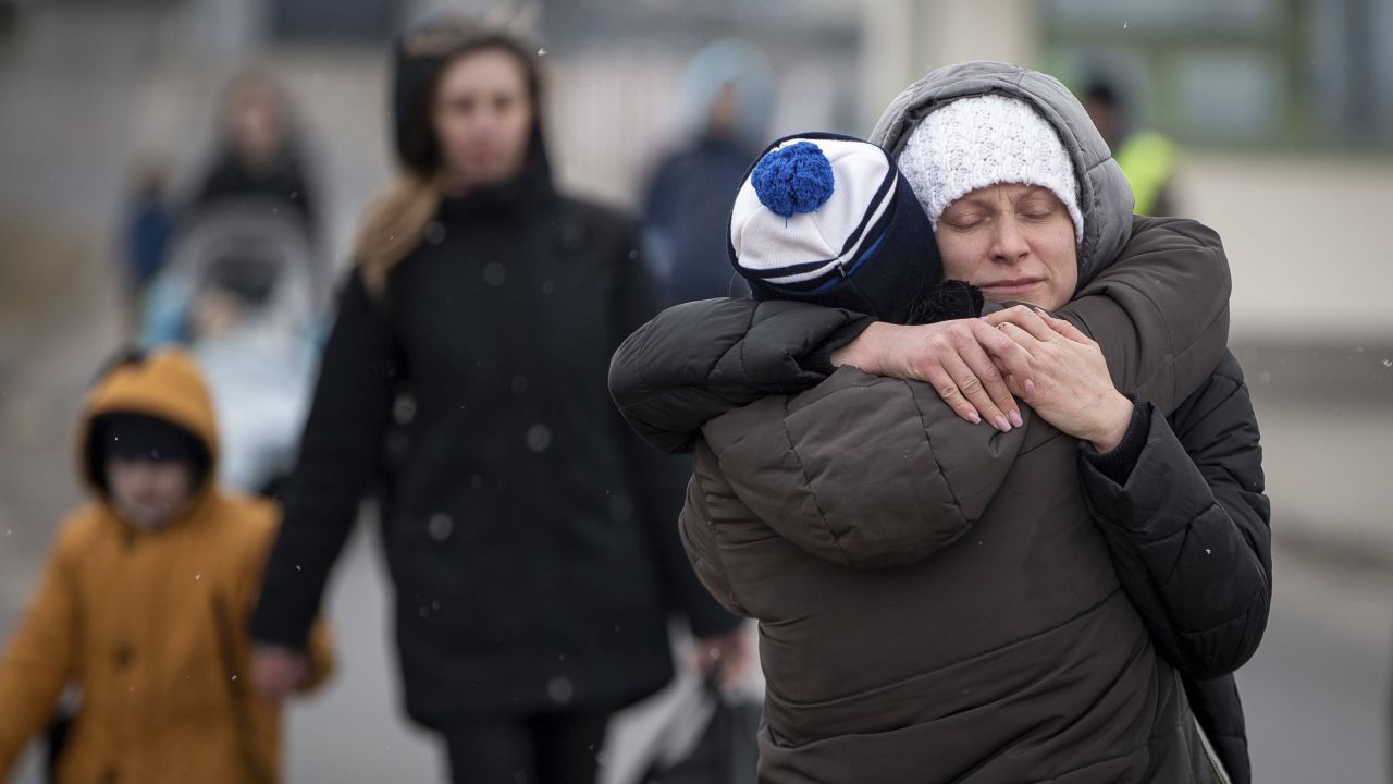 Refugees fleeing Ukraine reunite at the border crossing in Medyka, Poland, Monday, March 7, 2022. Russia announced yet another limited cease-fire and the establishment of safe corridors to allow civilians to flee some besieged Ukrainian cities Monday. But the evacuation routes led mostly to Russia and its ally Belarus, drawing withering criticism from Ukraine and others. (AP Photo/Visar Kryeziu)