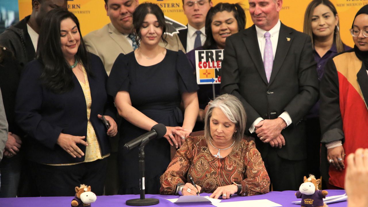 New Mexico Gov. Michelle Lujan Grisham signs into law SB 140, expanding free college tuition to most residents, in a ceremony at Western New Mexico University in Silver City on Friday, March 4.