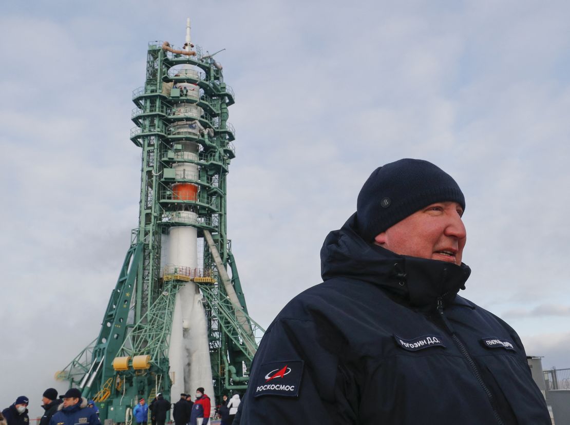 The head of Russia's Roscosmos space agency, Dmitry Rogozin, stands in front of the Soyuz MS-20 spacecraft at the Baikonur cosmodrome on December 8, 2021.