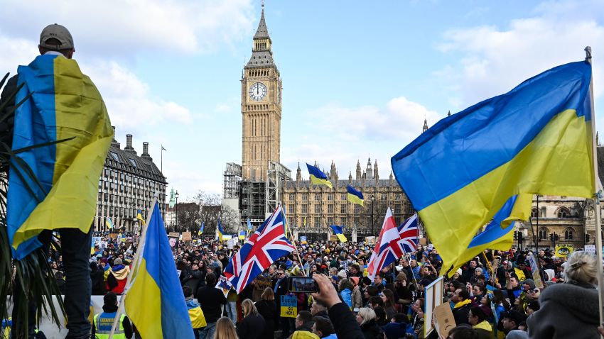 Demonstrators hold placards, Ukrainian and British flags during a protest rally for a Stop the War in Ukraine Global Day of Action, in central London, on March 6, 2022 as part of an international day of anti-war action, prompted by Russia's invasion of Ukraine. - Ukraine's President Zelensky has urged foreigners to head to Ukrainian embassies worldwide to sign up for an "international brigade" of volunteers to help fight invading Russian forces. He previously called on foreigners with combat experience to come to help defend his country, which has come under a withering Russian military assault from three sides since February 24. (Photo by JUSTIN TALLIS / AFP) (Photo by JUSTIN TALLIS/AFP via Getty Images)