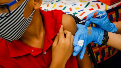 A child receives a dose of the Pfizer-BioNTech Covid-19 vaccine at an elementary school vaccination site for children in Miami on Monday, Nov. 22, 2021.