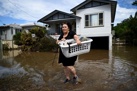 Patria Powell rescues items from her mother's flooded home in Woodburn, Australia, on March 7.