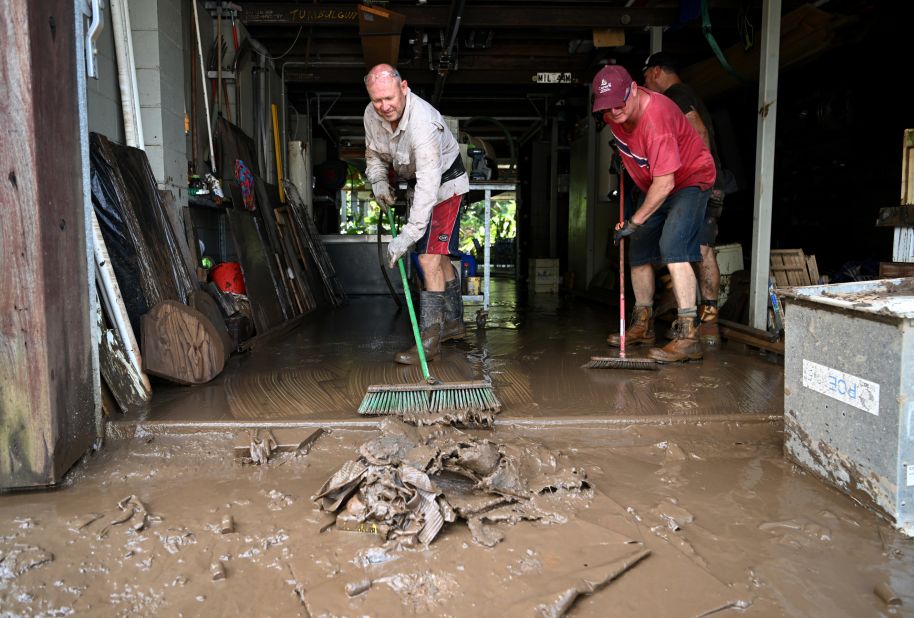 Craig Ashcroft, left, and Rob Beenhakker clean up a friend's home in Tumbulgum, Australia, on March 6.
