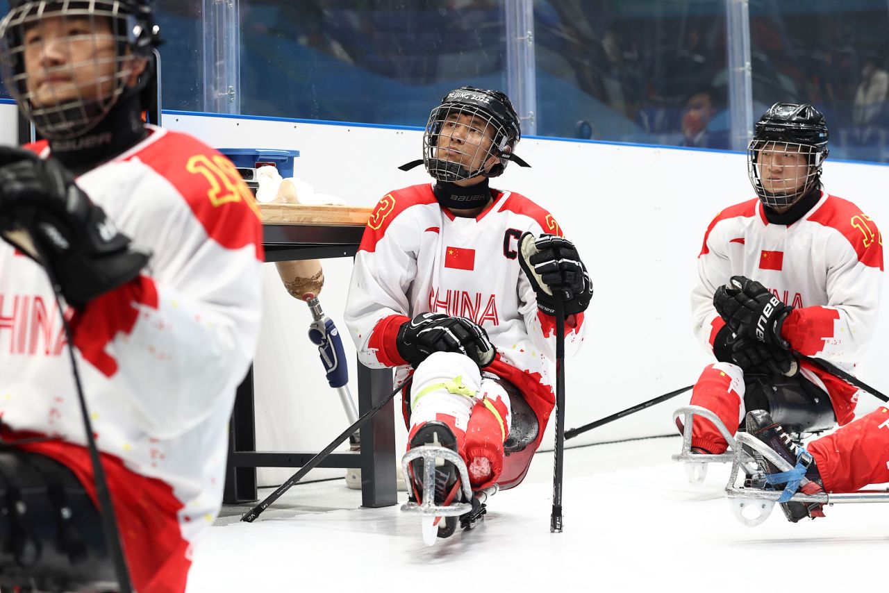 Chinese hockey players look on during a preliminary round game against Italy on March 8.
