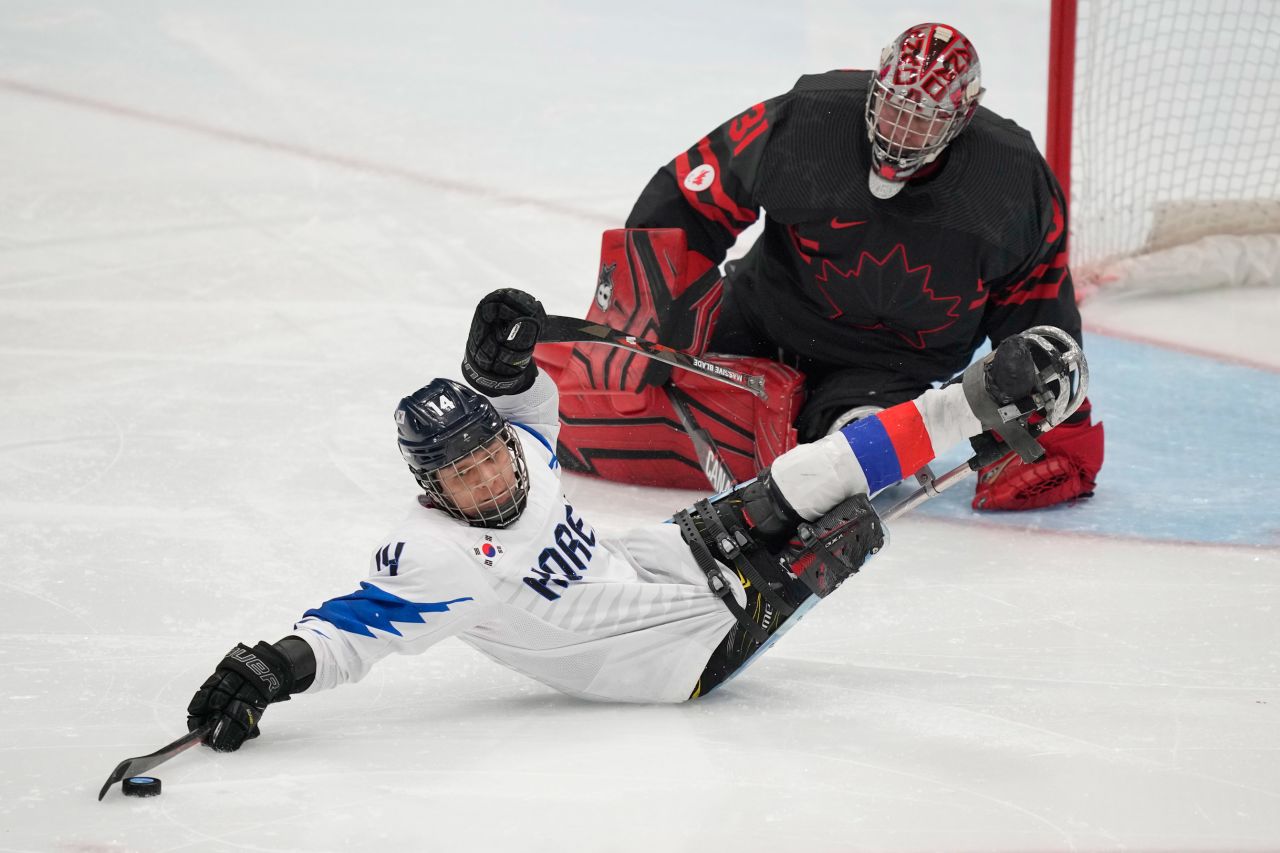 South Korea's Seung-Hwan Jung pulls in the puck near Canadian goaltender Dominic Larocque during a preliminary round hockey game on Tuesday, March 8.
