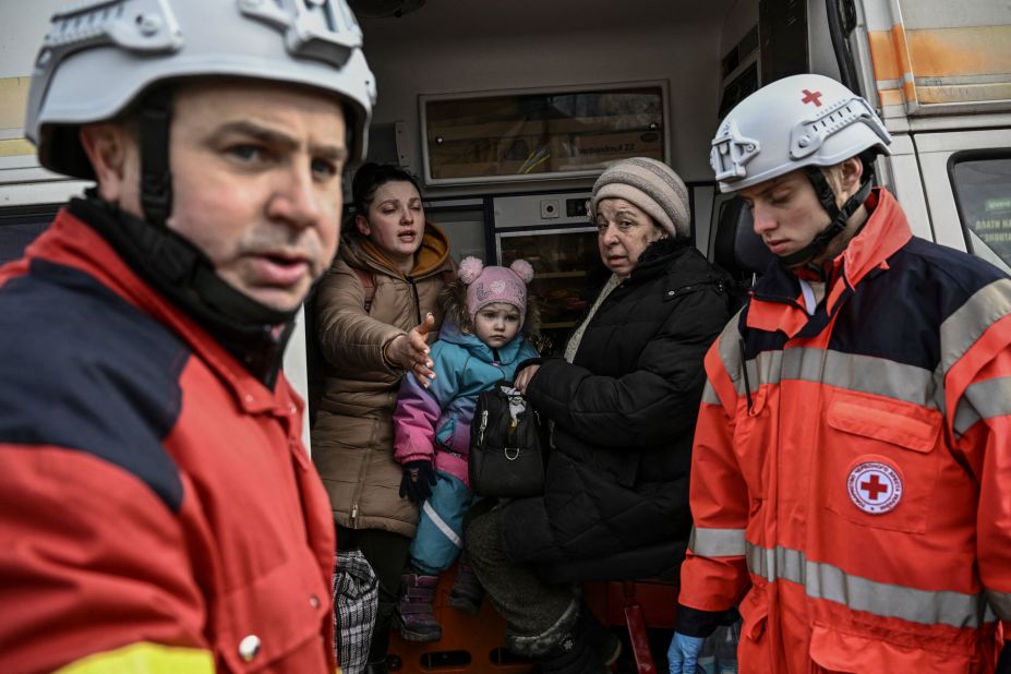 Members of the Red Cross help people fleeing the Kyiv suburb of Irpin on March 7.