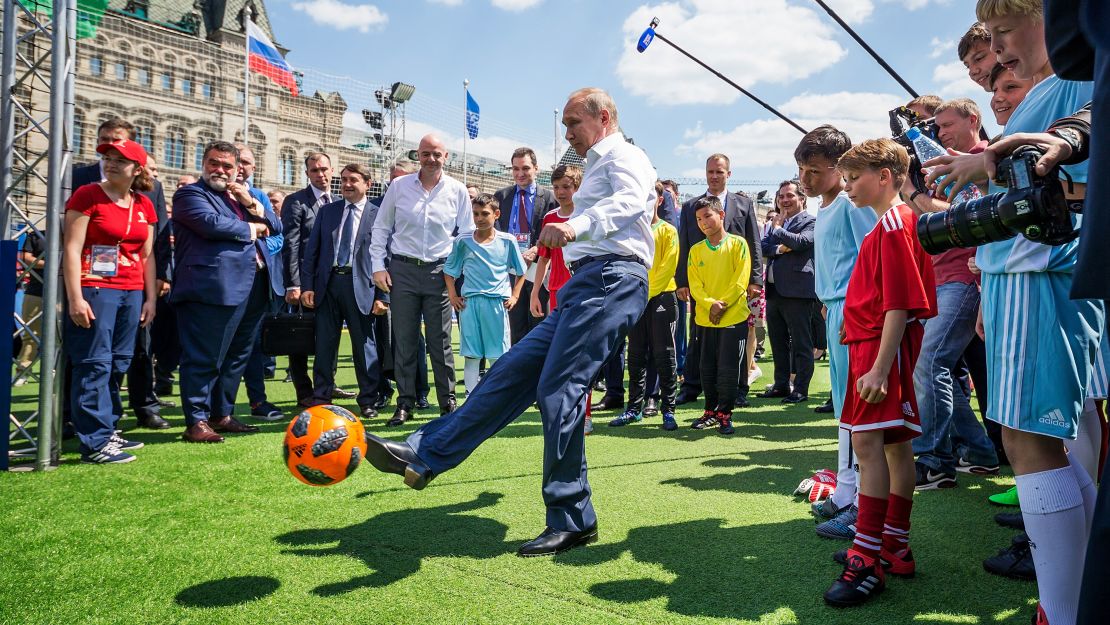 Vladimir Putin kicks a football during an event in the Red Square on June 28, 2018 in Moscow.