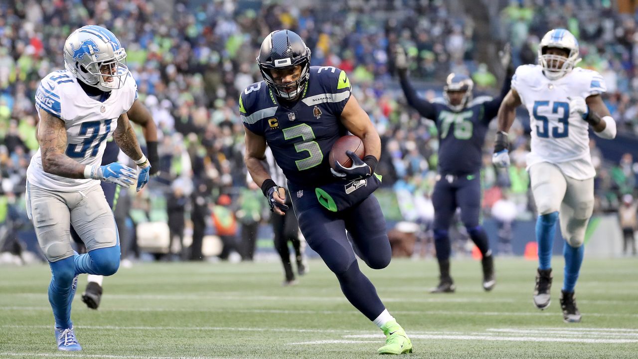  Russell Wilson runs the ball against the Detroit Lions during the fourth quarter of a game on January 2, 2022 in Seattle.