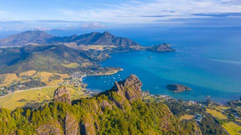 Aerial view of Taurikura bay behind mt. Manaia in New Zealand
