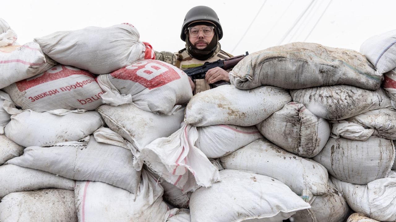 A member of Ukraine's Territorial Defense unit guards a barricade on the outskirts of eastern Kyiv on March 06, 2022.