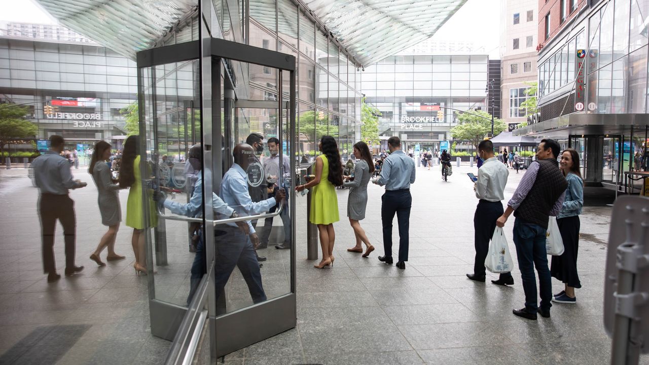 New York City office workers wait in line to enter Goldman Sachs headquarters in June 2021. The company has required Covid-19 vaccination for entry since August 24, 2021.