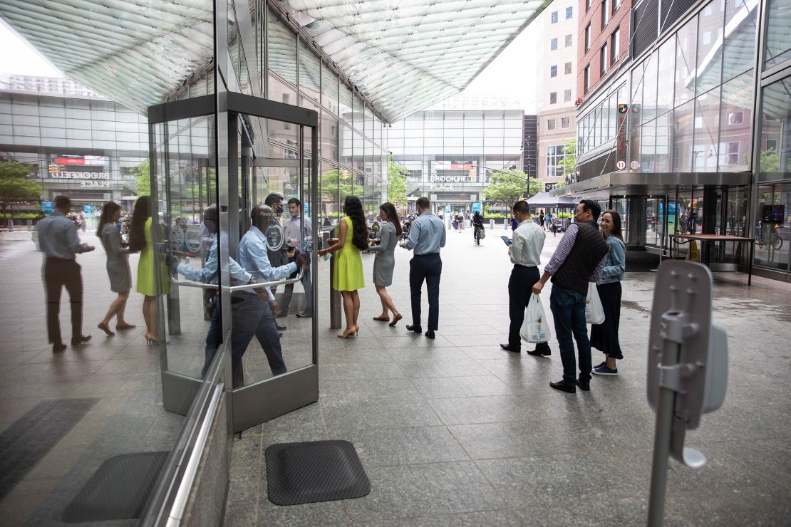 New York City office workers wait in line to enter Goldman Sachs headquarters in June 2021. The company has required Covid-19 vaccination for entry since August 24, 2021.