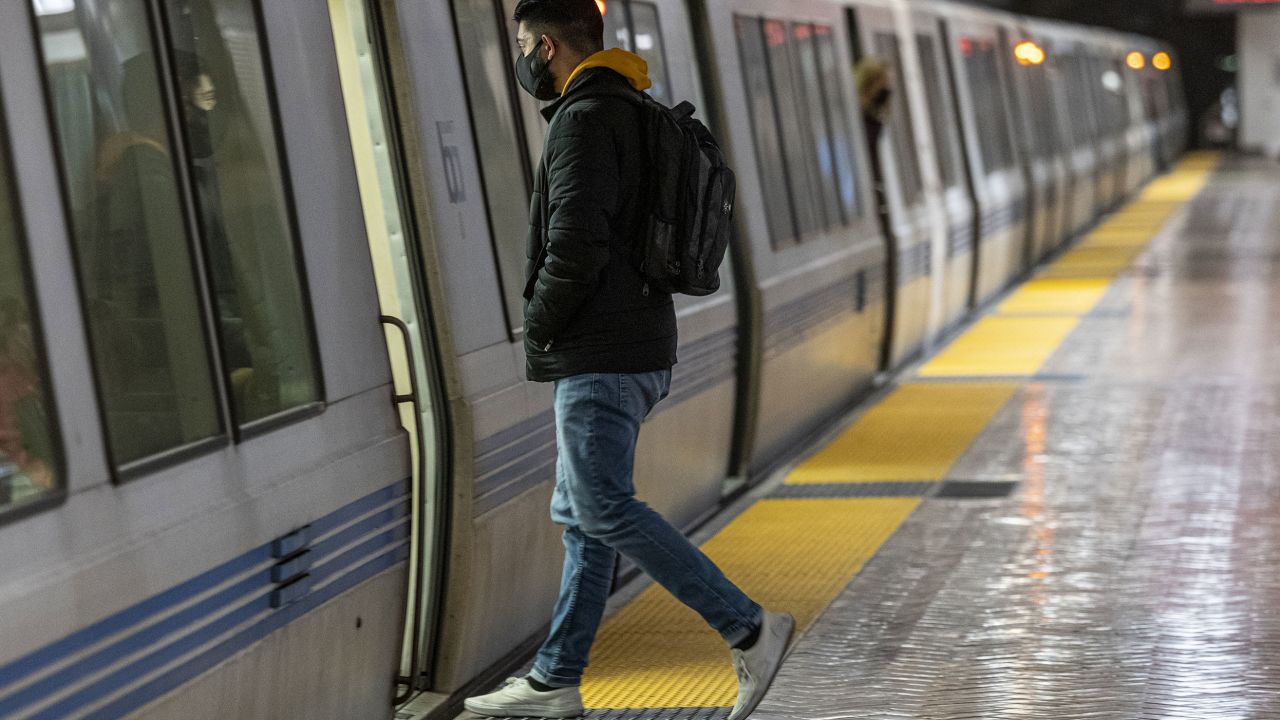 Do wear a mask while commuting on public mass transit, CNN Medical Analyst Dr. Leana Wen said. A commuter boards a Bay Area Rapid Transit train in San Francisco on March 4. 