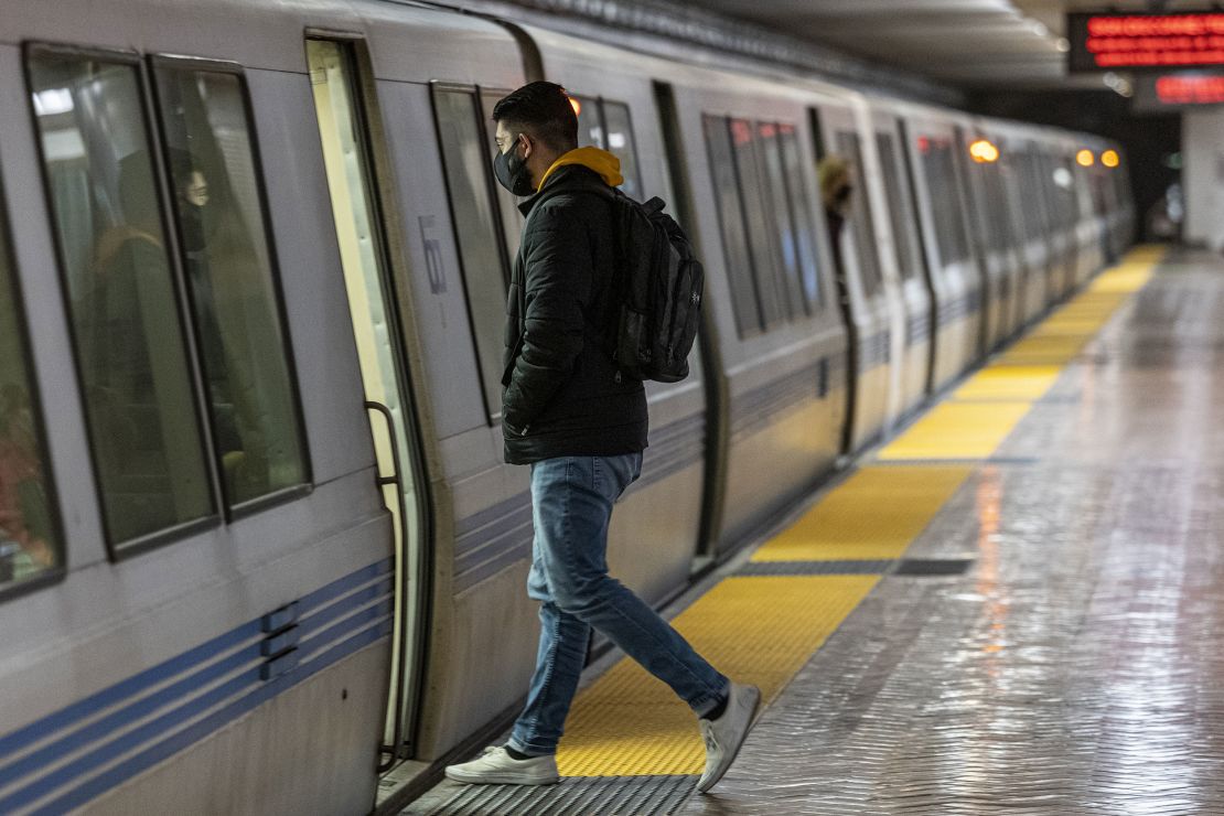 Do wear a mask while commuting on public mass transit, CNN Medical Analyst Dr. Leana Wen said. A commuter boards a Bay Area Rapid Transit train in San Francisco on March 4.