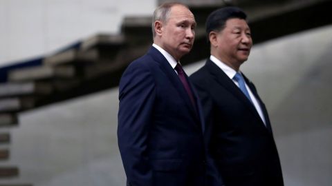 Russian President Vladimir Putin and Chinese leader Xi Jinping walk down the stairs as they arrive for a BRICS summit in Brasilia, Brazil in 2019.  