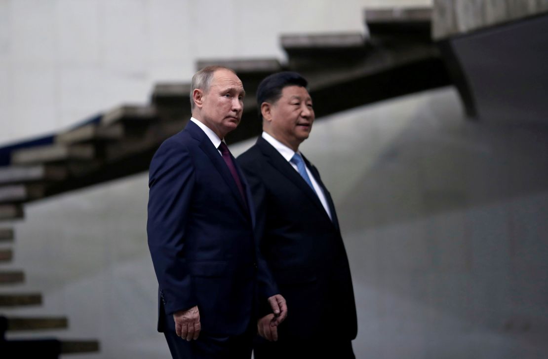 Russian President Vladimir Putin and Chinese leader Xi Jinping walk down the stairs as they arrive for a BRICS summit in Brasilia, Brazil in 2019.  