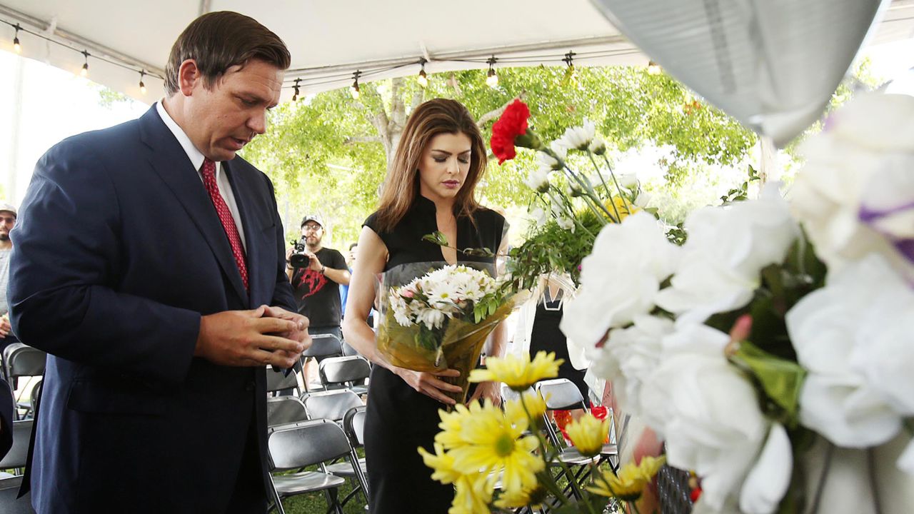 Florida Gov. Ron DeSantis and his wife, Casey, carry flowers to the site of the Pulse nightclub in Orlando, Fla., on Wednesday, June 12, 2019, marking the three-year anniversary of the Pulse nightclub shooting that killed 49 victims, many Hispanic and LGBTQ. 