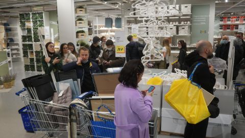 Shoppers wait in a line to pay for their purchases at the IKEA store March 3, 2022 in Moscow.
