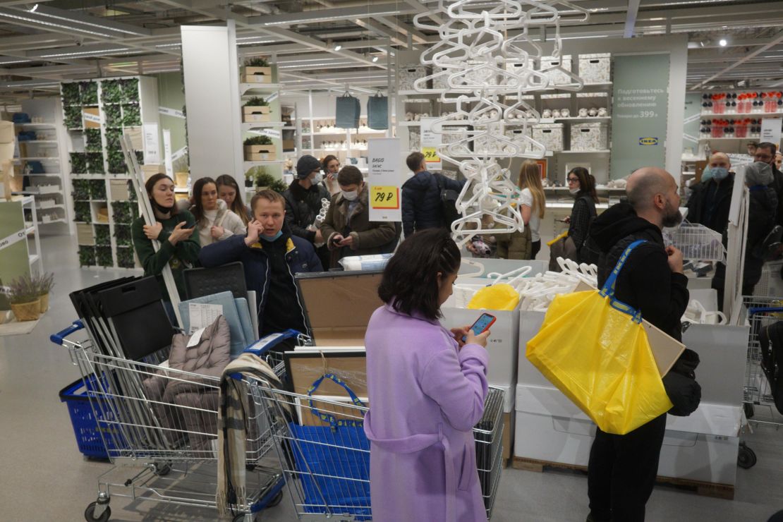 Shoppers wait in a line to pay for their purchases at the IKEA store March 3, 2022 in Moscow.