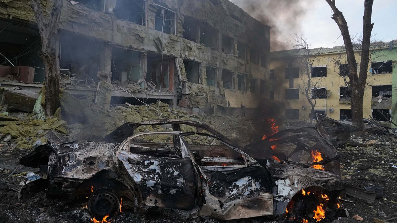 A car burns at the side of the maternity hospital on Wednesday.
