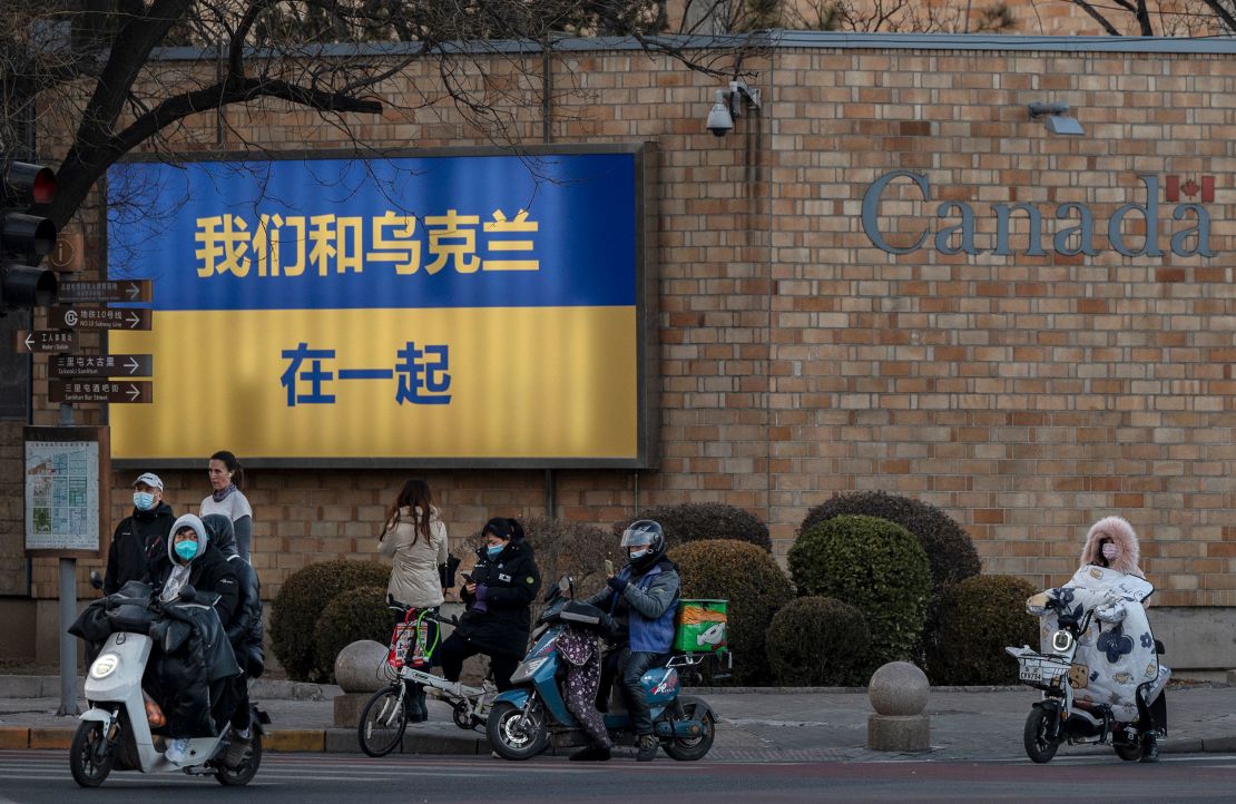 A large Ukrainian flag with the slogan "We Stand With Ukraine" written on it in Chinese characters is seen on the outside wall of the Canadian Embassy on March 1, 2022 in Beijing, China. 