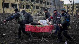 Ukrainian emergency employees and volunteers carry an injured pregnant woman from the damaged by shelling maternity hospital in Mariupol, Ukraine, Wednesday, March 9, 2022. 