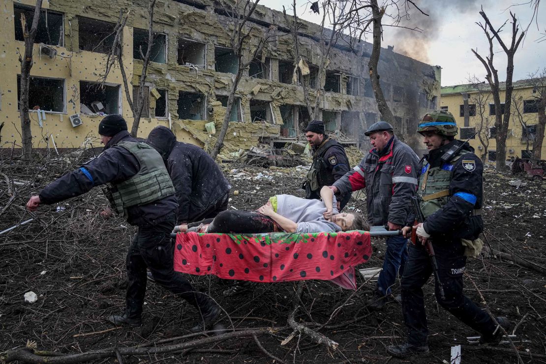 Ukrainian emergency workers carry an injured pregnant woman from the damaged maternity hospital in Mariupol, Ukraine, on Wednesday.