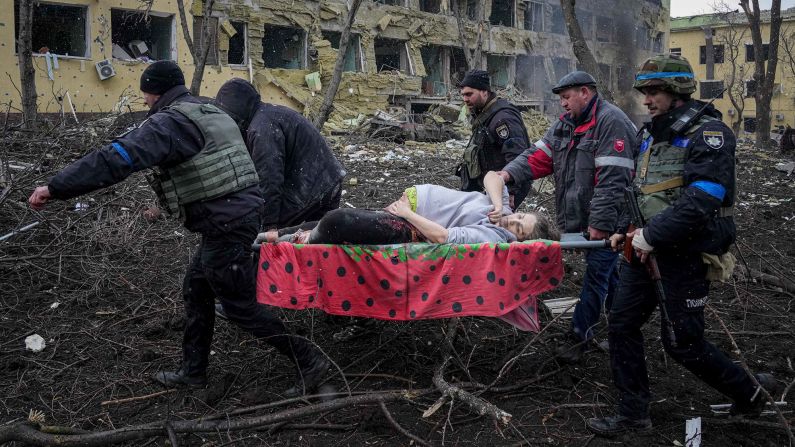 Ukrainian emergency workers carry an injured pregnant woman outside of a bombed maternity hospital in Mariupol, Ukraine, on Wednesday, March 9. Despite efforts to resuscitate the woman and her baby, <a href="index.php?page=&url=https%3A%2F%2Fwww.cnn.com%2F2022%2F03%2F14%2Feurope%2Fmariupol-pregnant-woman-baby-death-intl%2Findex.html" target="_blank">both later died.</a>