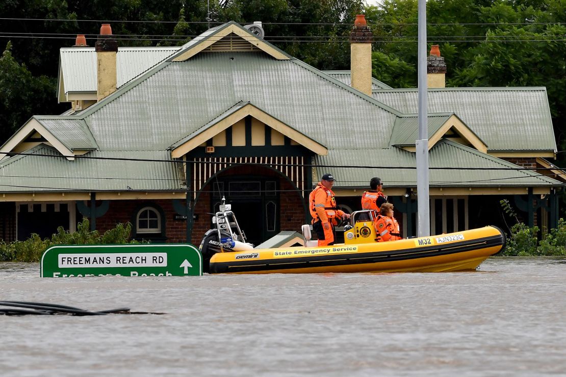 Rescue volunteers patrol around the flooded houses in the Sydney suburb of Windsor, March 9.
