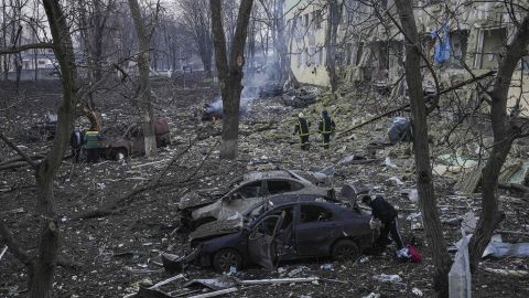 Ukrainian emergency employees work at the hospital damaged by shelling in Mariupol.