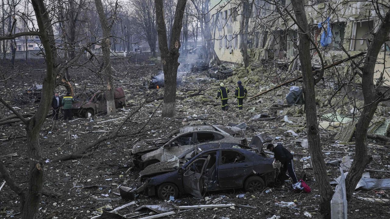 Ukrainian emergency employees work at the hospital damaged by shelling in Mariupol.