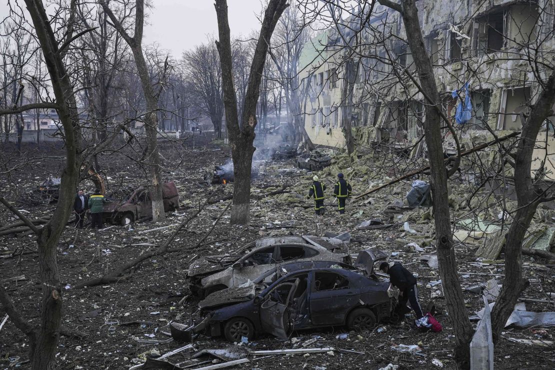 Ukrainian emergency employees work at the hospital damaged by shelling in Mariupol.