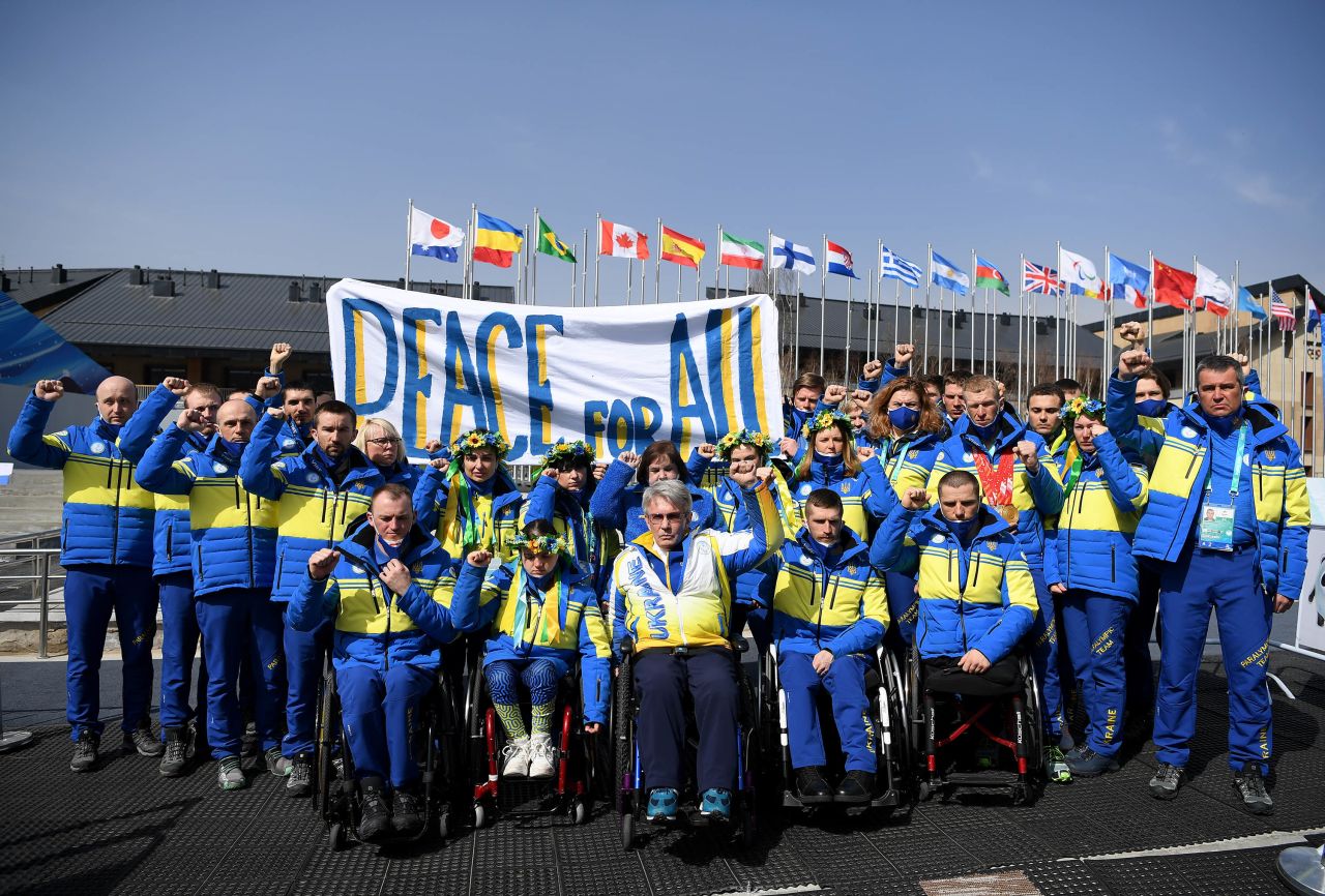 Members of Ukraine's Paralympic Team hold a banner reading "peace for all" in the athletes' village on March 10.