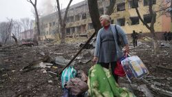 A woman walks outside a maternity hospital that was damaged by shelling in Mariupol, Ukraine, Wednesday, March 9, 2022. (AP Photo/Evgeniy Maloletka)