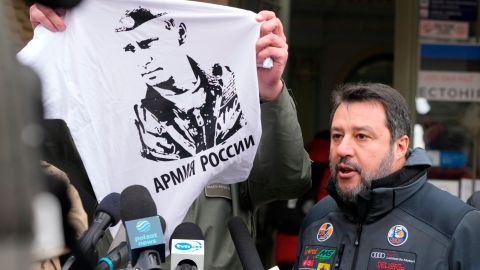 The mayor of Przemysl holds up a T-shirt with the likeness of Vladimir Putin as Matteo Salvini speaks with journalists on March 8, 2022. 