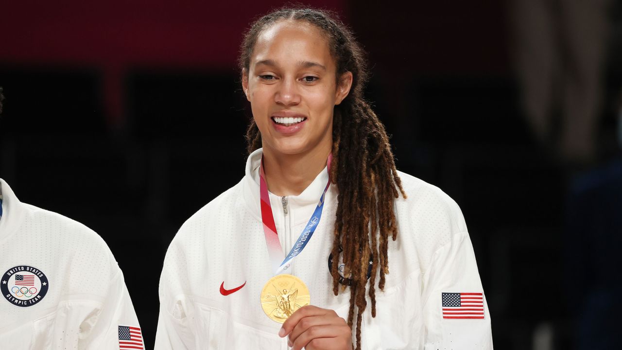 Griner poses for photographs with her gold medal during Tokyo 2020.