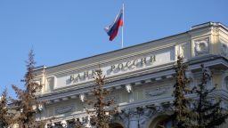 A Russian national flag above the headquarters of Bank Rossii, Russia's central bank, in Moscow, Russia, on Monday, Feb. 28, 2022. The Bank of Russia acted quickly to shield the nations $1.5 trillion economy from sweeping sanctions that hit key banks, pushed the ruble to a record low and left President Vladimir Putin unable to access much of his war chest of more than $640 billion. Photographer: Andrey Rudakov/Bloomberg via Getty Images