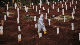 JAKARTA, INDONESIA - SEPTEMBER 11: A municipal cemetery worker walks through  a special cemetery for suspected  Covid-19 victims on September 11, 2020 in Jakarta, Indonesia. Jakartas governor, Anies Baswedan, has ordered the reimposition of strict measures to curtail rising cases of the Covid-19 Coronavirus, starting Monday Sept. 14 due to an alarming shortage of ICU and quarantine beds in hospitals treating an increasing number of COVID-19 patients.(Photo by Ed Wray/Getty Images)