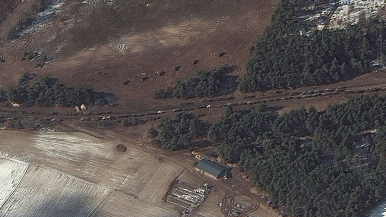 In Berestyanka -- 10 miles west of the airbase -- a number of fuel trucks and what Maxar says appear to be multiple rocket launchers are seen positioned in a field near trees.