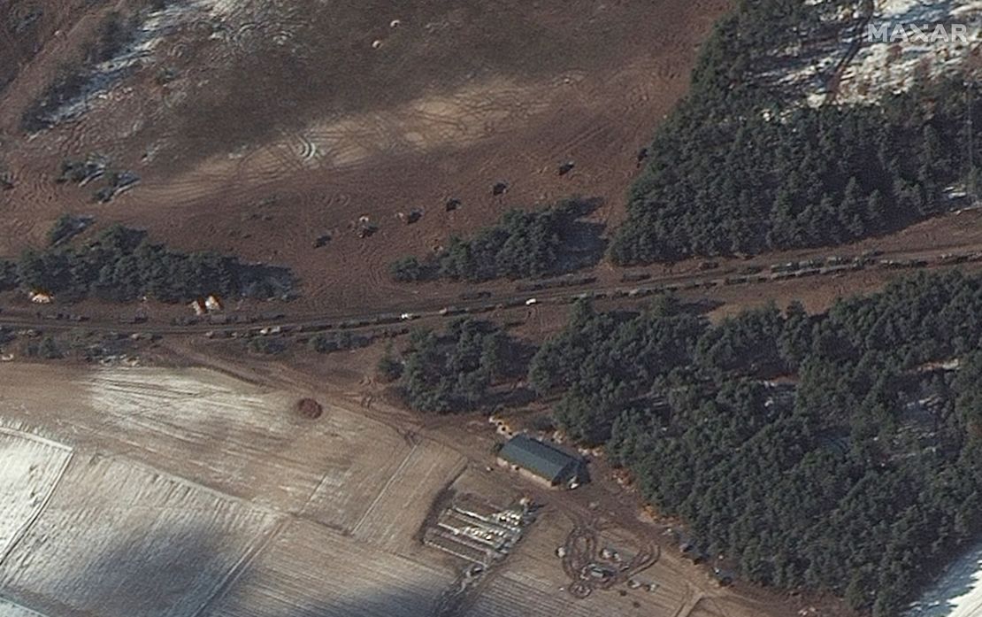 In Berestyanka -- 10 miles west of the airbase -- a number of fuel trucks and what Maxar says appear to be multiple rocket launchers are seen positioned in a field near trees.