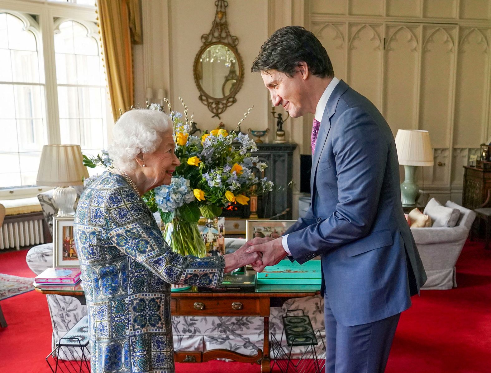 Britain's Queen Elizabeth II shakes hands with Canadian Prime Minister Justin Trudeau as they meet at Windsor Castle in England on Monday, March 7.