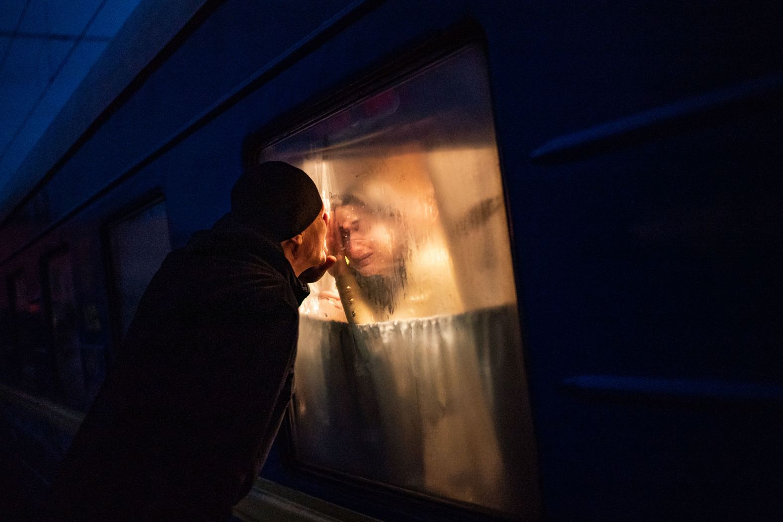 George Keburia says goodbye to his wife and children as they board a train in Odessa, Ukraine, on Saturday, March 5. They were heading to Lviv in the western part of the country.