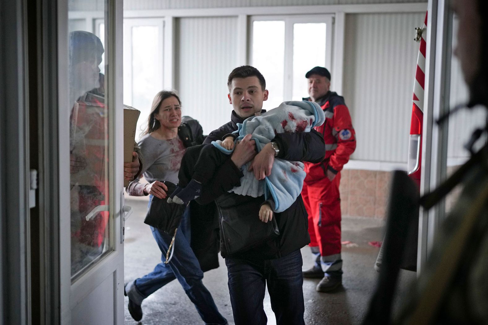 Marina Yatsko runs behind her boyfriend, Fedor, as they arrive at the hospital with her 18-month-old son, Kirill, who was wounded by shelling in Mariupol, Ukraine, on Friday, March 4. Medical workers frantically tried to save the boy's life, <a href="index.php?page=&url=https%3A%2F%2Fwww.cnn.com%2Feurope%2Flive-news%2Fukraine-russia-putin-news-03-05-22%2Fh_c7b21aabcd03d680d3467e41057b5a86" target="_blank">but he didn't survive.</a>