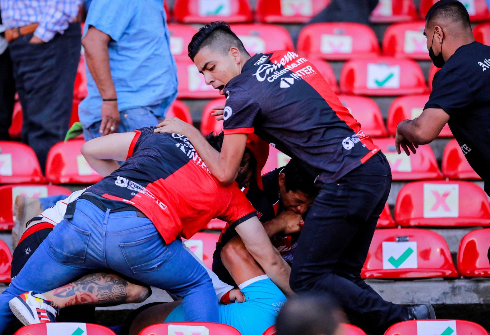 People fight in the stands of a pro soccer game in Querétaro City, Mexico, on Saturday, March 5. At least 26 people were injured in the <a href="index.php?page=&url=https%3A%2F%2Fwww.cnn.com%2F2022%2F03%2F06%2Ffootball%2Fqueretaro-atlas-soccer-brawl-mexico-spt-intl%2Findex.html" target="_blank">mass brawl</a> that forced the game to be abandoned in the second half.