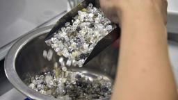 An employee pours rough diamonds in Alrosa's diamond sorting center in the town of Mirny, Russia.