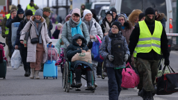 KORCZOWA, POLAND - MARCH 10: Women, children and elderly people fleeing war-torn Ukraine walk into Poland at the Korczowa border crossing on March 10, 2022 at Korczowa, Poland. Over one million people have arrived in Poland from Ukraine since the Russian invasion of February 24, and while many are now living with relatives who live and work in Poland, others are journeying onward to other countries in Europe.  (Photo by Sean Gallup/Getty Images)