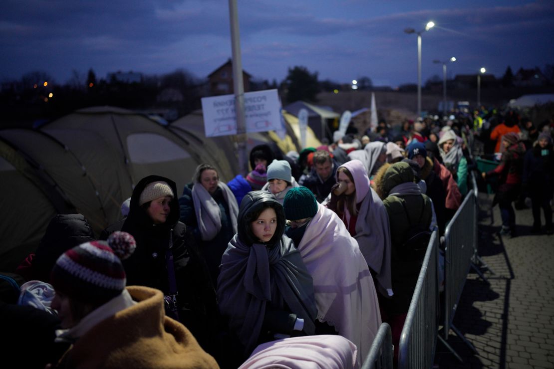 Refugees fleeing war in neighboring Ukraine queue at the Medyka border crossing, Poland, Thursday, March 10, 2022.