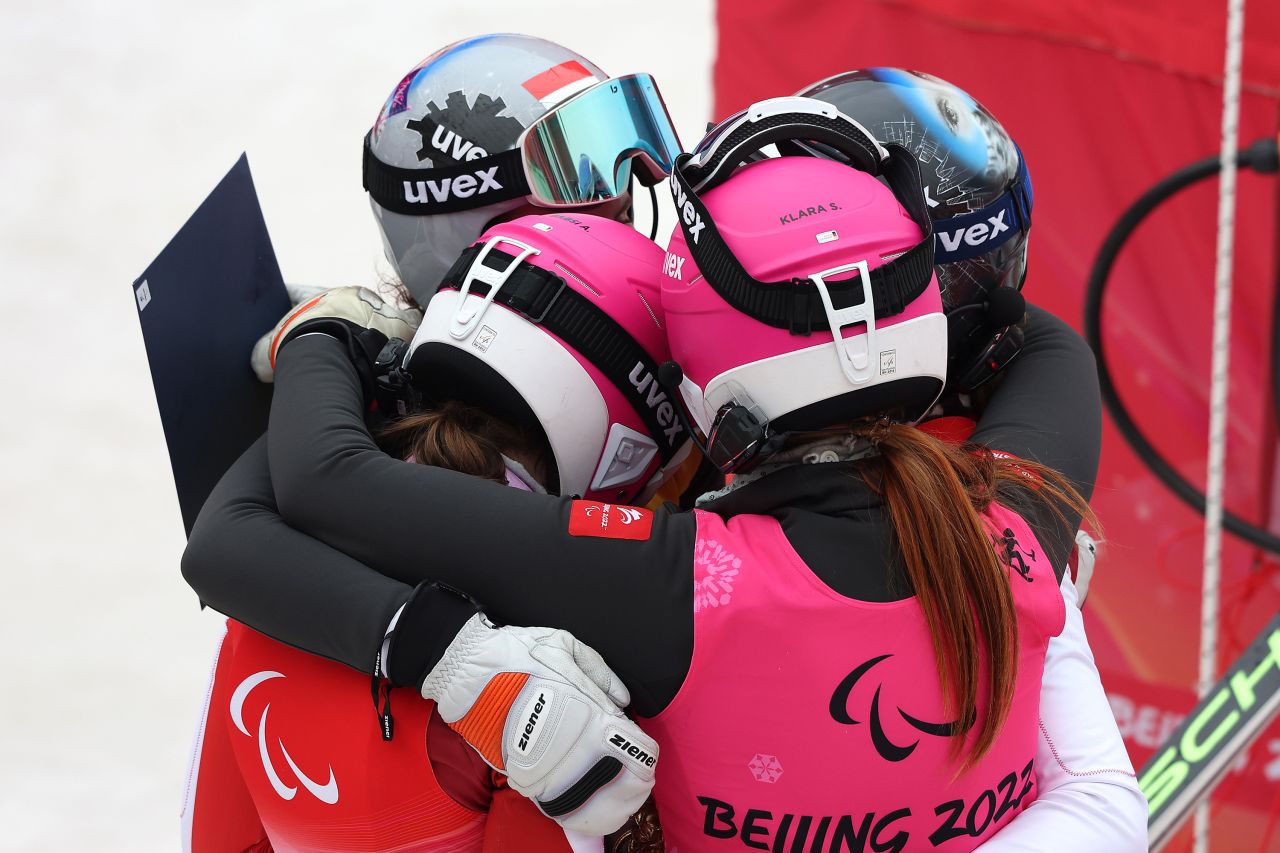 Austria's Veronika Aigner and Barbara Aigner hug their guides, one of whom is their sister Elisabeth, after skiing a giant slalom race on March 11. Veronika won the gold and Barbara won the bronze. Their brother Johannes has already won two golds, one silver and one bronze at these Paralympics.